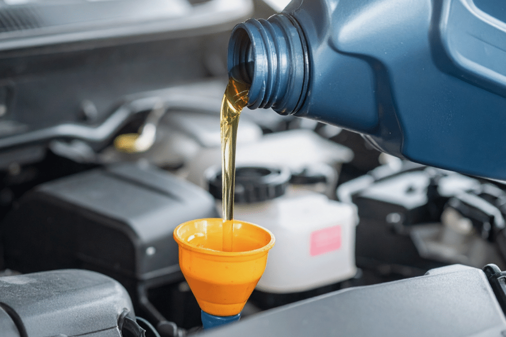 Oil Change in Shawnee, OK At Miller Brothers Automotive. Image of motor oil being poured into a car engine