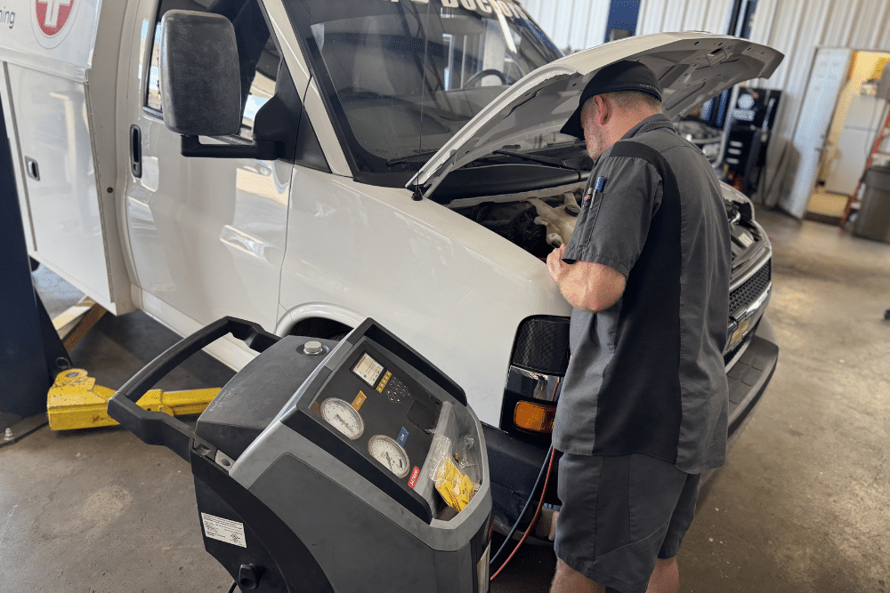 AC Repair, Auto Repair for McLoud, OK At Miller Brothers Automotive. Image of Mechanic using an A/C recharge machine on a commercial van.